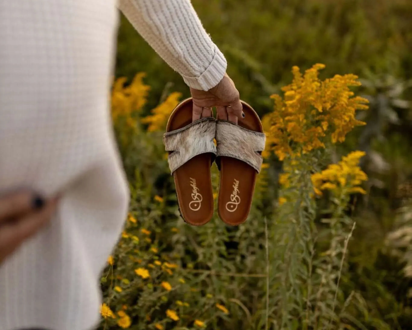 Tara cowhide sandals on cork footbed backdrop