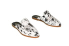 black and white hair-on-hide mules with leather sole
