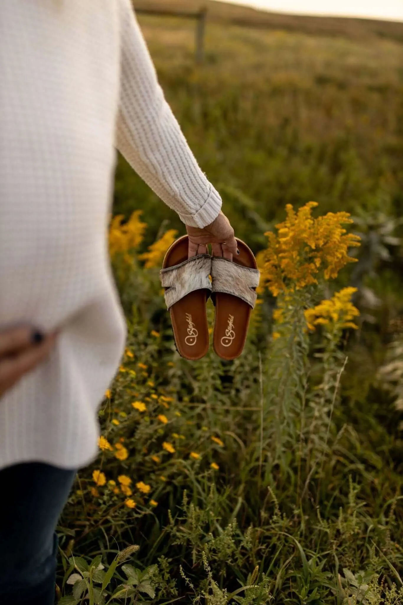 Tara cowhide sandals on cork footbed backdrop